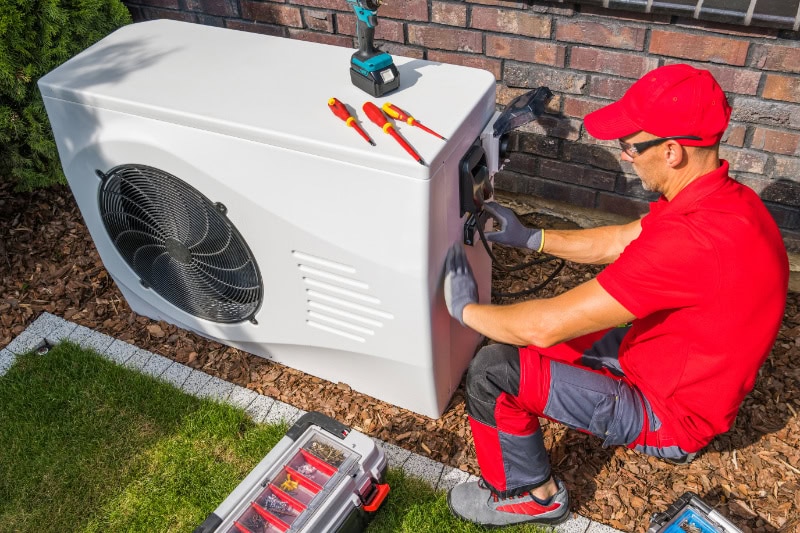 Tech working on heat pump.